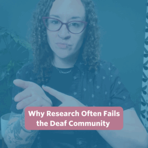 The post features a video thumbnail with a blue overlay. At the center, a text bubble reads “Why Research Often Fails the Deaf Community” in white text on a rose-colored background. In the video, Bee, a white, non-binary person with long, curly brown hair, stands in front of a forest green wall. A potted monstera plant is visible on the left. Bee is wearing a black top layered under a charcoal short-sleeve button-up shirt and maroon glasses.