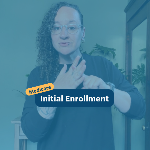 The post has a video thumbnail with blue shading overlaid. The top middle has "Medicare: Initial Enrollment” in white text with light blue background, accompanied by a yellow bubble with “Medicare” in blue. In the video: A nonbinary person with long, curly brown hair shaved on the right side of their head stands in front of the camera. Behind them is a light wooden entry table with a potted monstera plant set against a green wall. They are wearing black pants and a black sweater with two gold chain necklaces.
